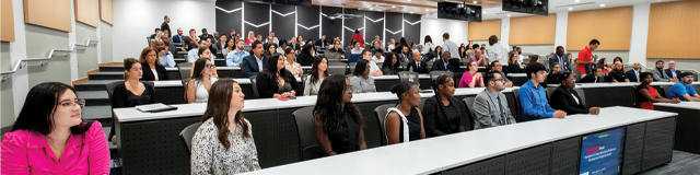 Group of Executive Education students in a large classroom