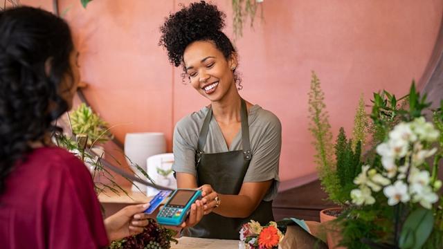 Cashier and customer making a transaction